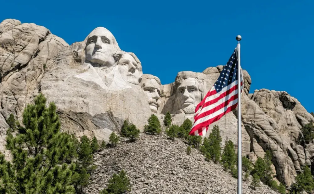 American flag waiving in front of Mount Rushmore